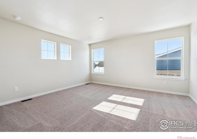 spare room featuring light colored carpet