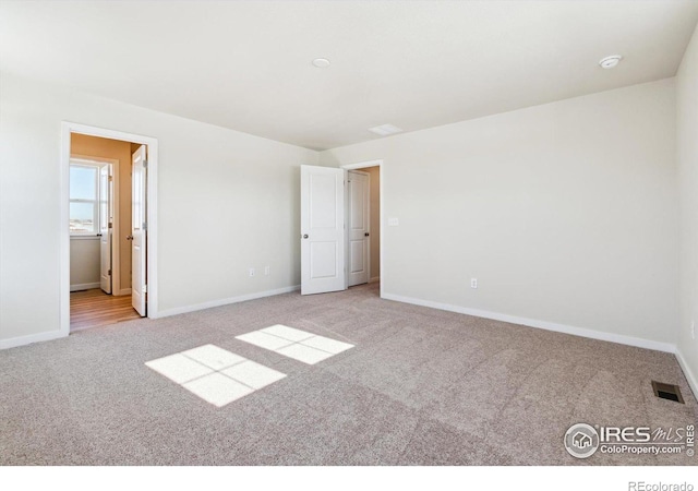 unfurnished bedroom featuring light carpet