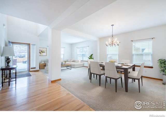 dining space with a chandelier and light hardwood / wood-style floors