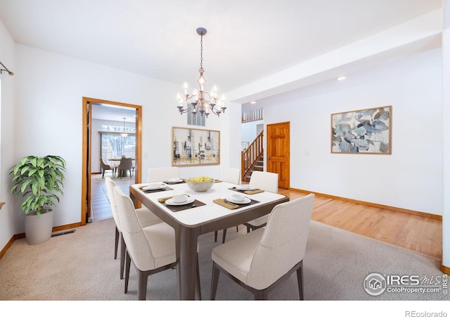 dining room featuring a notable chandelier and light hardwood / wood-style flooring