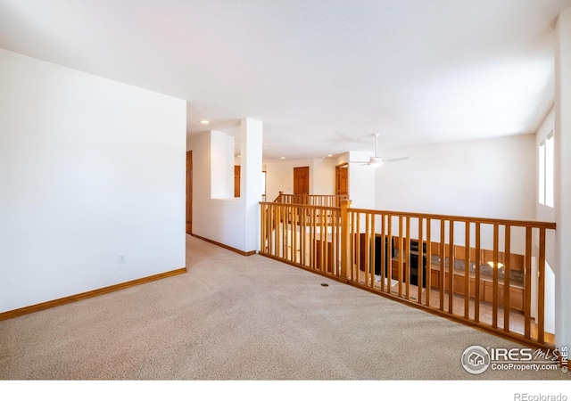 carpeted empty room with ceiling fan