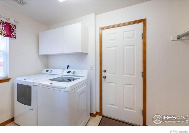 washroom with washer and clothes dryer and cabinets