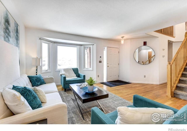 living room featuring dark wood-type flooring and a textured ceiling