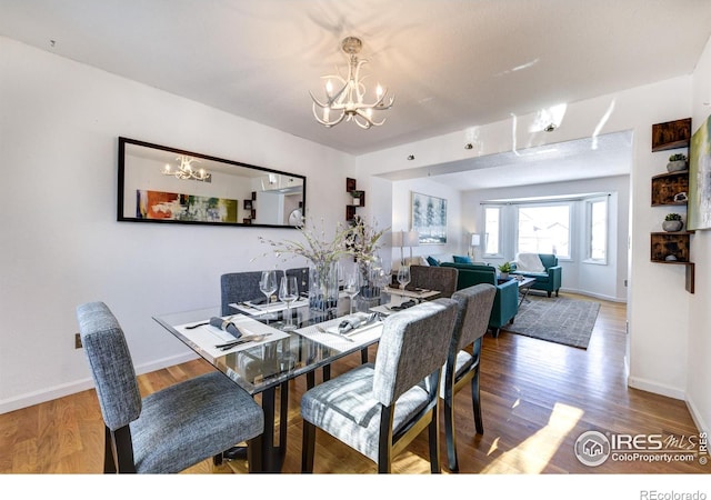 dining space featuring a chandelier and hardwood / wood-style floors