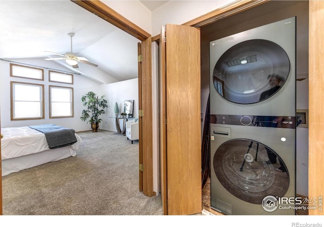 laundry area with ceiling fan, stacked washer / drying machine, and light carpet