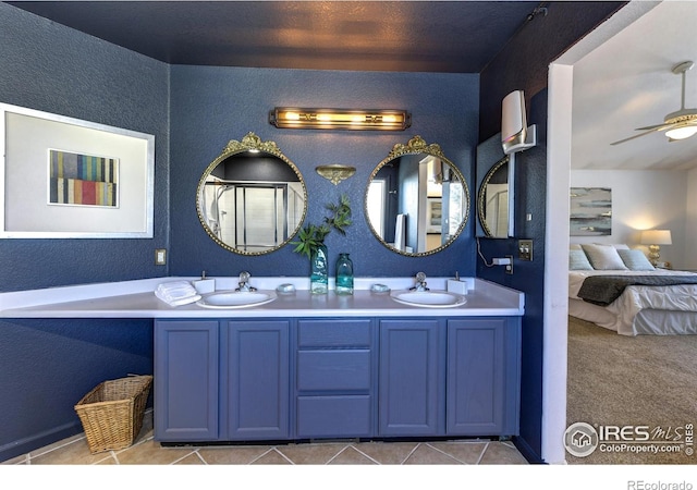 bathroom featuring tile patterned flooring, vanity, and ceiling fan