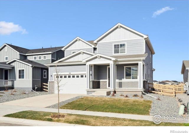 view of front of home featuring a garage, a front yard, and covered porch