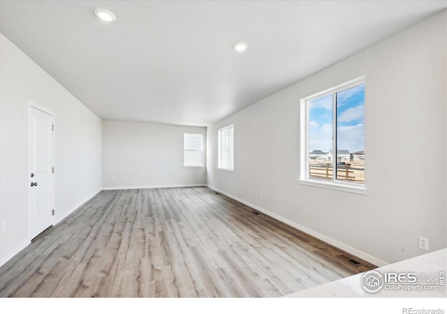 unfurnished room with light hardwood / wood-style floors