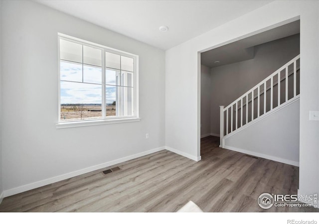 spare room with light hardwood / wood-style flooring