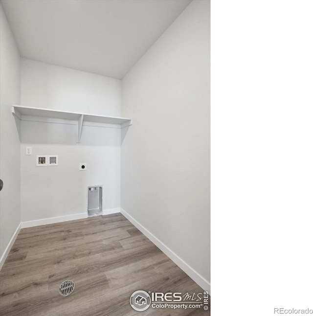 laundry area with hookup for a washing machine, hookup for an electric dryer, and light hardwood / wood-style floors