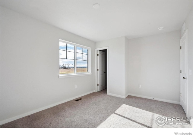 unfurnished bedroom with light colored carpet