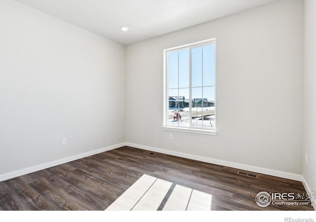 spare room with dark hardwood / wood-style floors