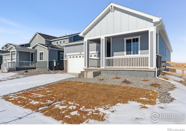 view of front of property featuring a porch and a garage