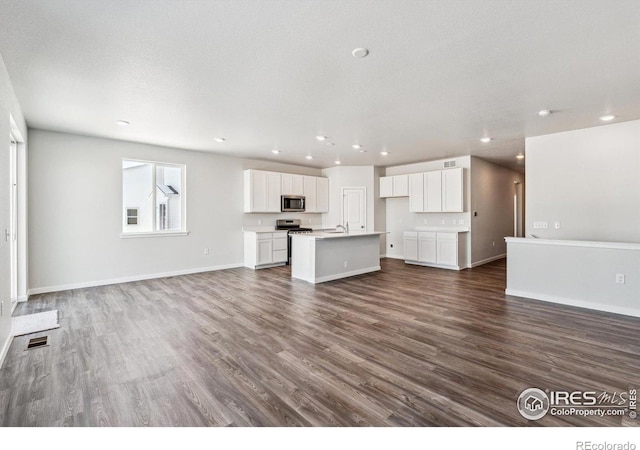 unfurnished living room with hardwood / wood-style flooring and a textured ceiling