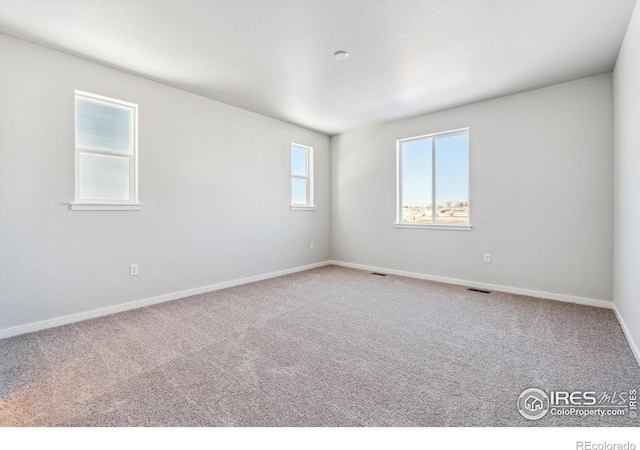 unfurnished room featuring carpet