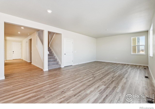 empty room with light hardwood / wood-style flooring