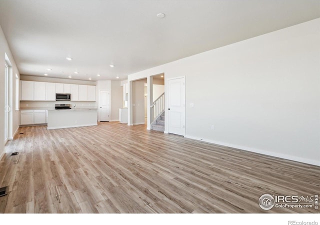 unfurnished living room featuring light hardwood / wood-style floors