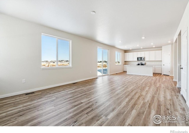 unfurnished living room with light wood-type flooring