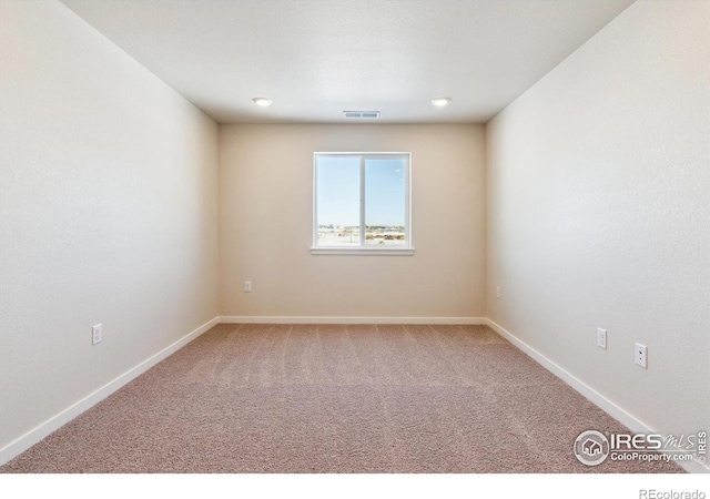 unfurnished room featuring carpet