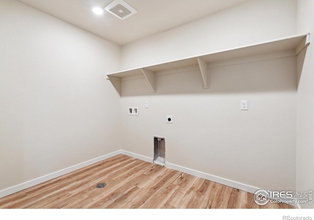 clothes washing area with hardwood / wood-style flooring, washer hookup, and hookup for an electric dryer