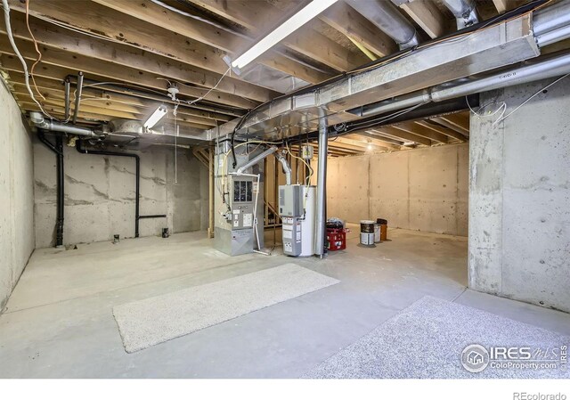 unfinished basement with water heater and heating unit