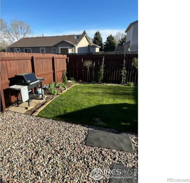 view of yard featuring a fenced backyard and a residential view