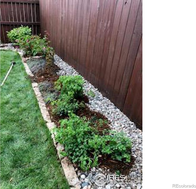 view of yard with a garden and fence