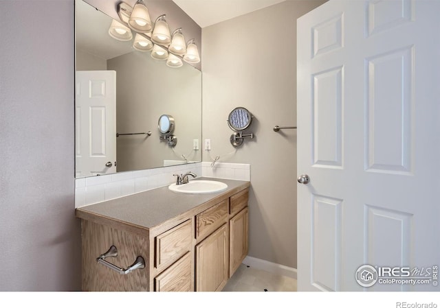 bathroom with vanity and baseboards