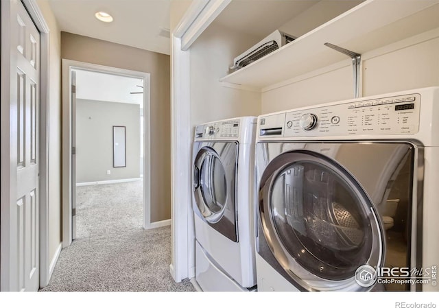 laundry area with independent washer and dryer, baseboards, laundry area, and light colored carpet