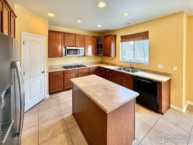 kitchen with light tile patterned flooring, appliances with stainless steel finishes, a center island, and sink