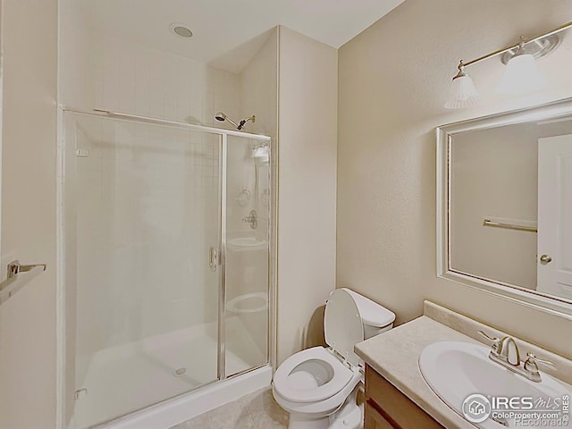 bathroom featuring vanity, an enclosed shower, and toilet