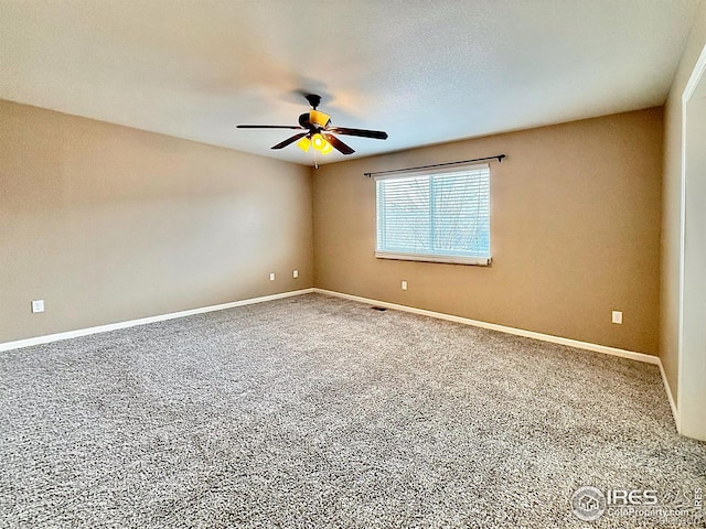 empty room with ceiling fan and carpet