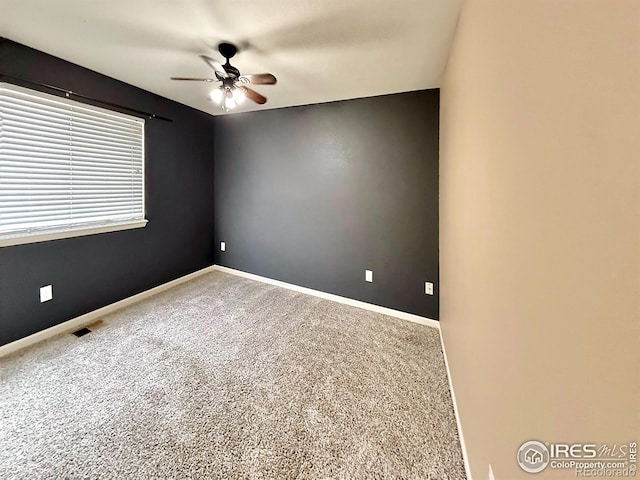 carpeted spare room with ceiling fan