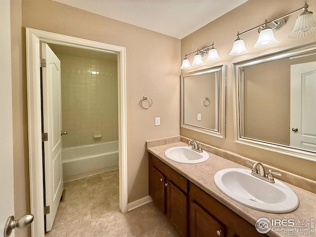 bathroom featuring vanity, tile patterned floors, and tiled shower / bath