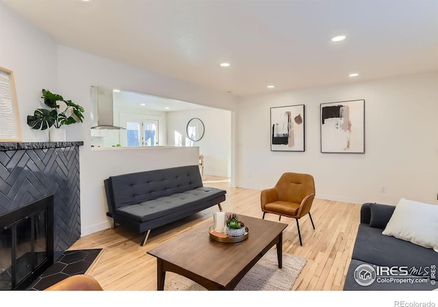 living room with a fireplace and light hardwood / wood-style floors