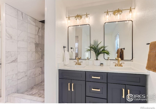 bathroom featuring a tile shower and vanity