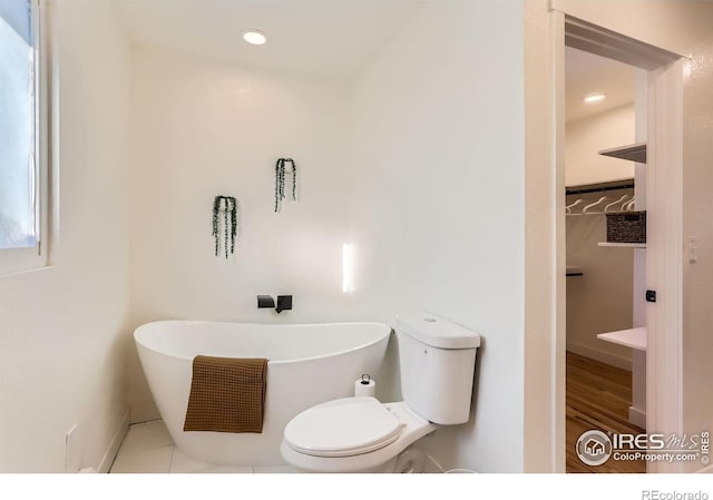 bathroom with a bathing tub and toilet