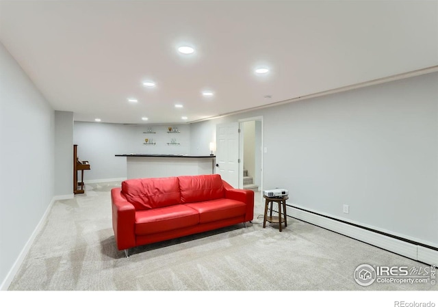 carpeted living room with a baseboard heating unit