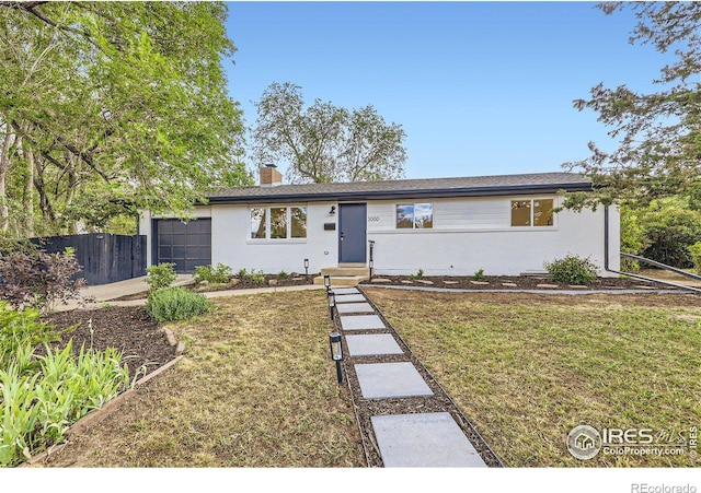 single story home featuring a garage and a front yard