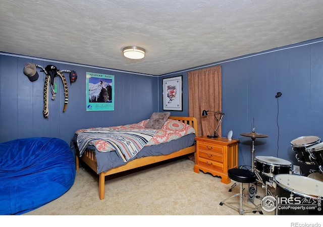 bedroom featuring carpet flooring and a textured ceiling