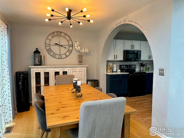 dining room featuring light hardwood / wood-style flooring and a textured ceiling