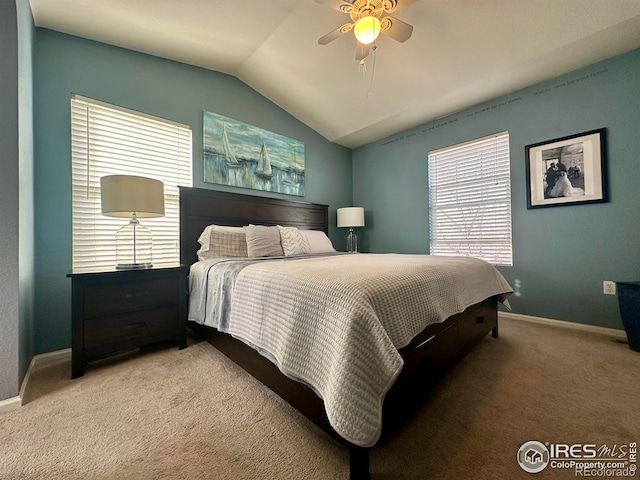 carpeted bedroom with ceiling fan and vaulted ceiling