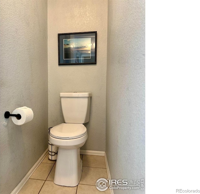 bathroom featuring tile patterned flooring and toilet