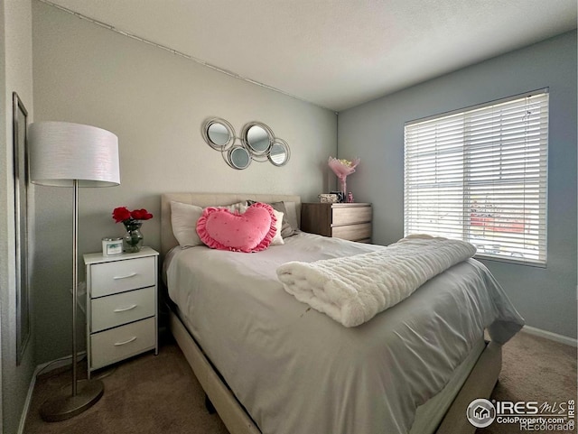 bedroom featuring dark carpet