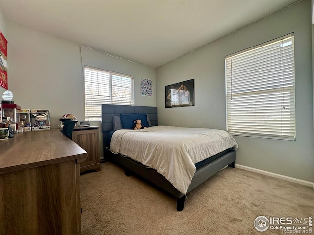 bedroom featuring light colored carpet