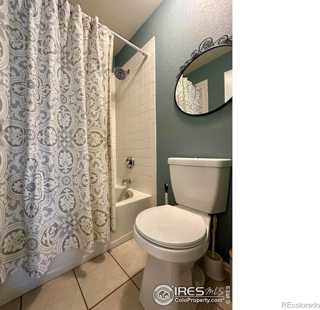 bathroom with shower / bath combination with curtain, tile patterned floors, toilet, and a textured ceiling