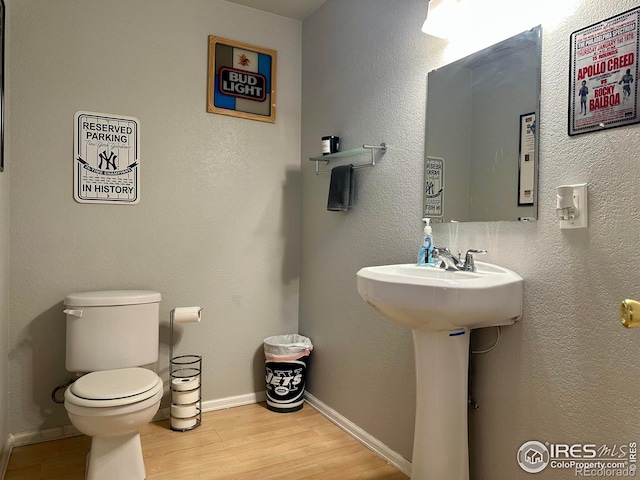 bathroom featuring toilet and hardwood / wood-style floors