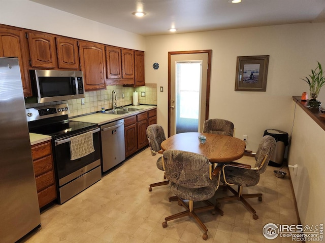 kitchen featuring appliances with stainless steel finishes, sink, and backsplash