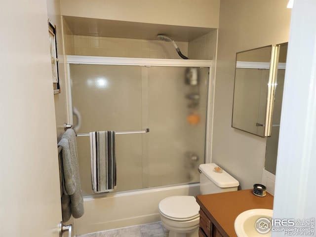 full bathroom with vanity, toilet, and combined bath / shower with glass door