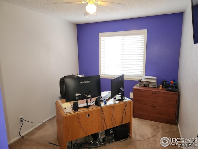 office space featuring light carpet, a textured ceiling, and ceiling fan